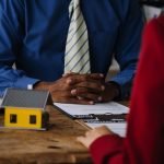 real-estate-broker-agent-presenting-consult-customer-decision-making-sign-insurance-form-agreement-buy-sell-home-model-concerning-mortgage-loan-offer-house-insurance_265022-23568